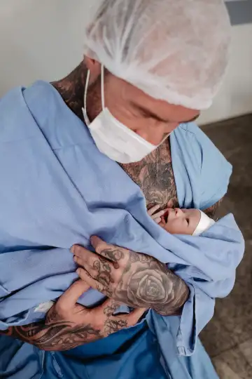 Proud Father Embracing Baby